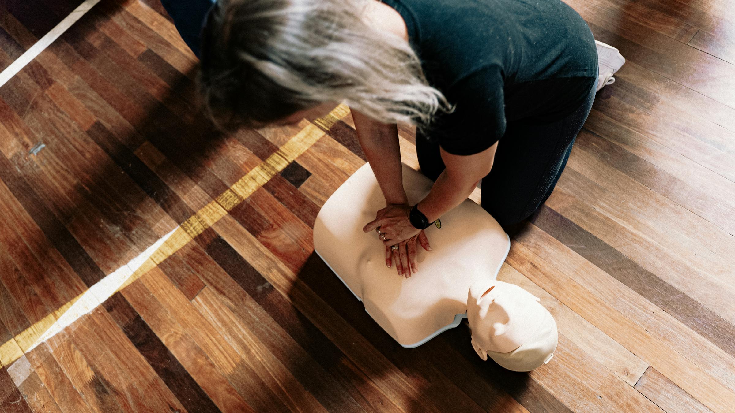 Instructor demonstrating CPR steps to trainees